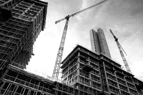 Construction worker with safety equipment working on wooden beams